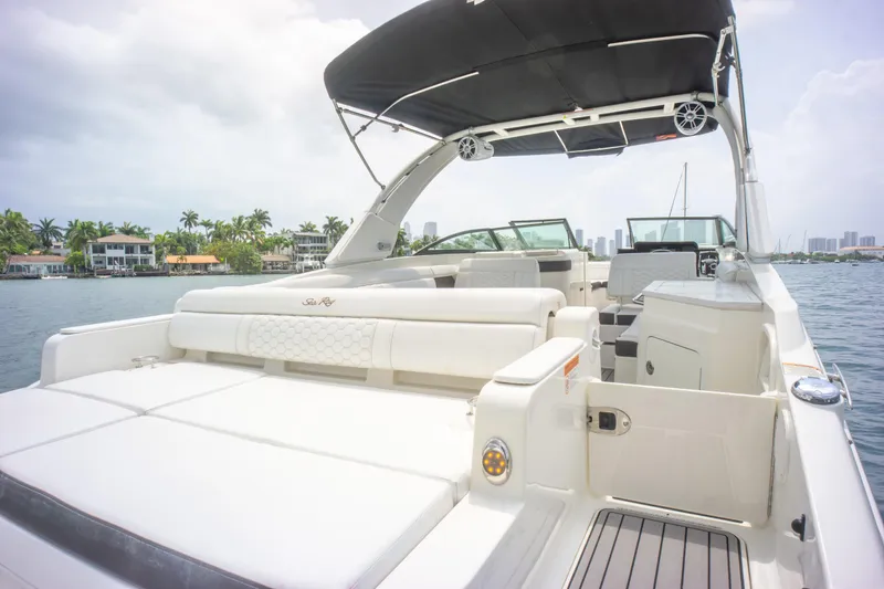  Yacht Photos Pics 2022 Sea Ray SDX 290 Outboard boat with spacious seating and canopy on a sunny day.