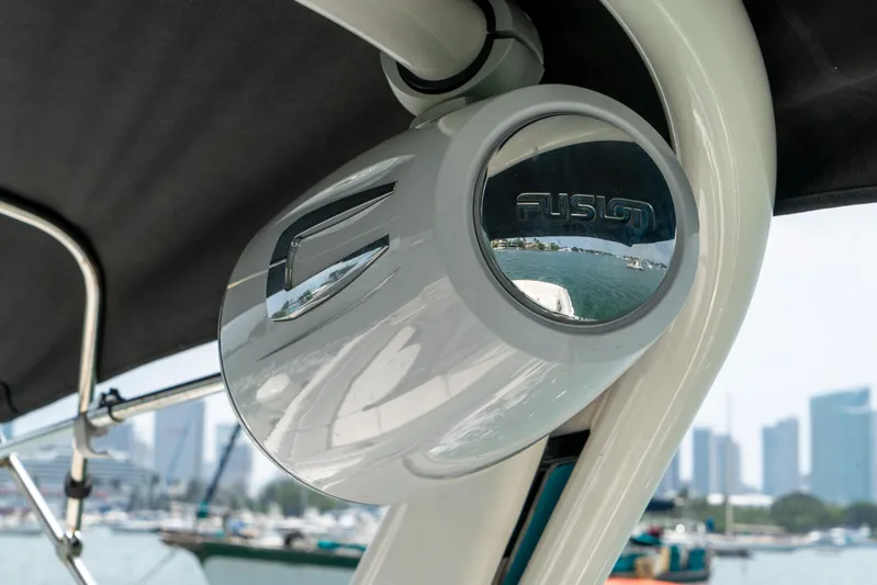  Yacht Photos Pics 2022 Sea Ray SDX 290 Outboard with Fusion marine speaker, city skyline in background.