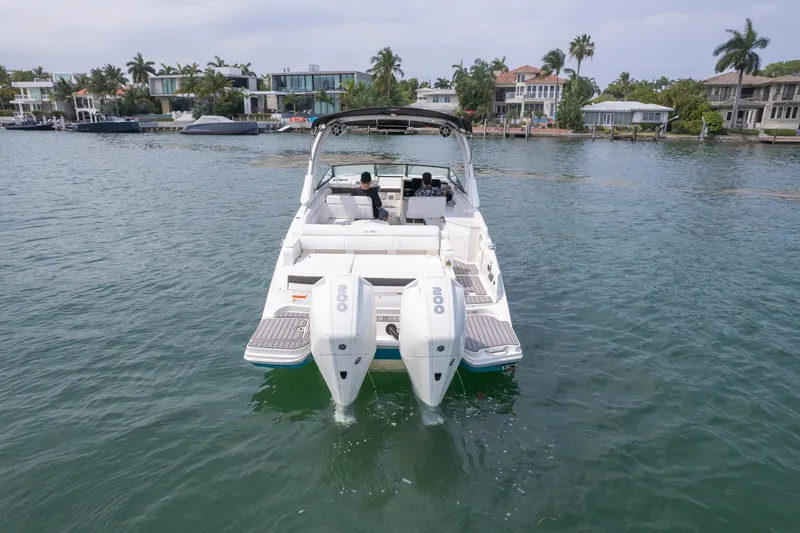 Yacht Photos Pics 2022 Sea Ray SDX 290 Outboard boat on water, with dual engines, near waterfront homes.