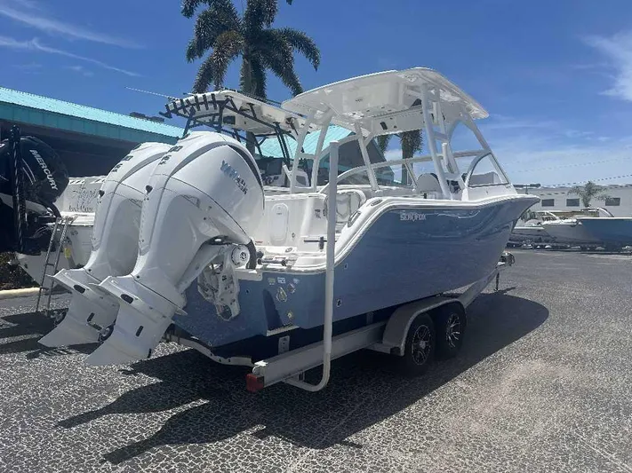 Black Label Marine Yacht Photos Pics 2026 Sea Fox 288 Traveler boat with dual engines on a trailer, parked outdoors.