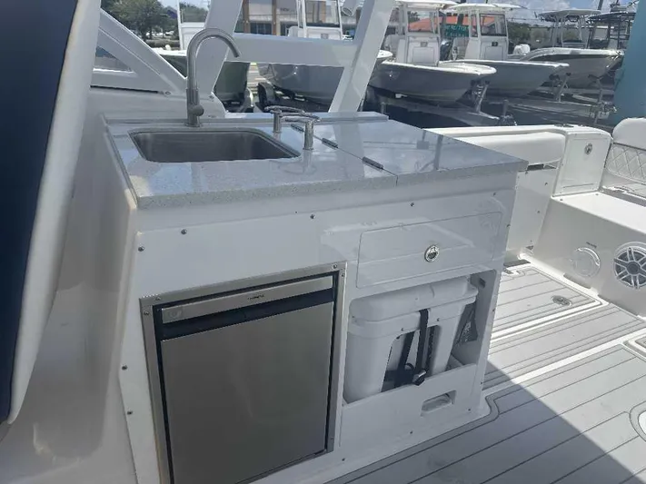 Black Label Marine Yacht Photos Pics 2026 Sea Fox 288 Traveler boat kitchenette with sink, fridge, and storage compartments.