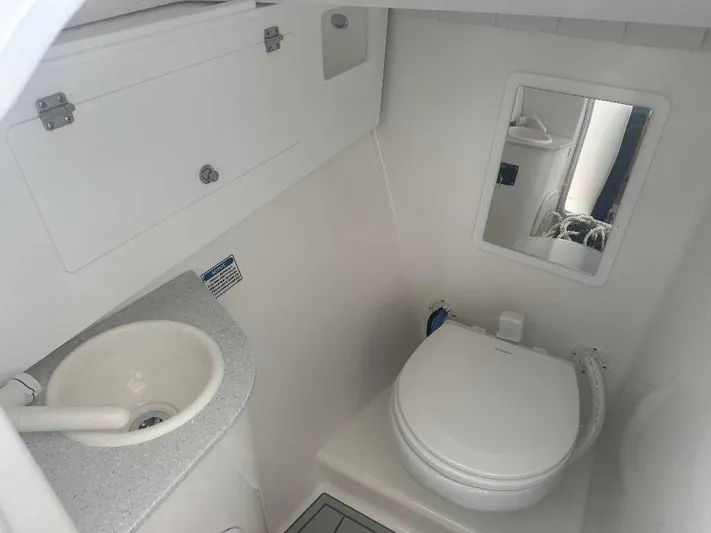 Black Label Marine Yacht Photos Pics 2026 Sea Fox 288 Traveler boat bathroom with sink, toilet, and mirror.