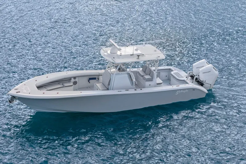 Yacht Photos Pics 2026 Yellowfin 32 Offshore boat on clear blue water, featuring twin Mercury engines.