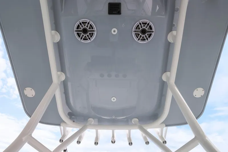  Yacht Photos Pics 2026 Yellowfin 32 Offshore boat roof with speakers and rod holders against blue sky.