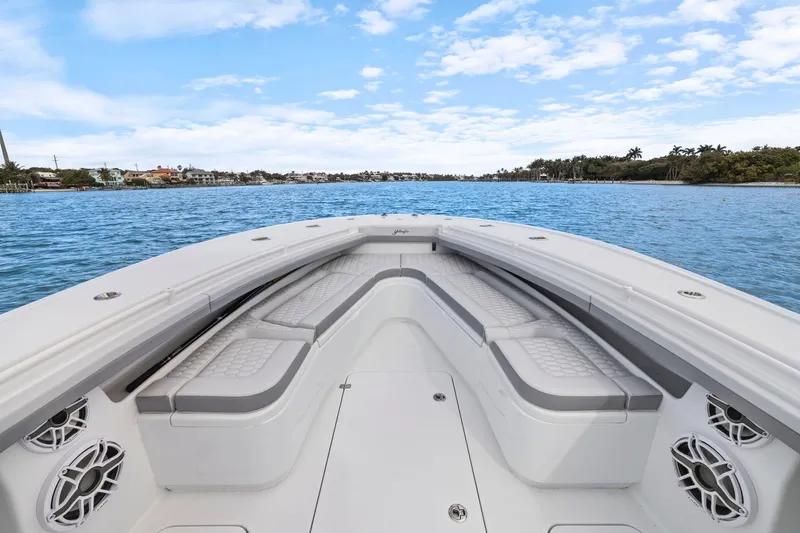  Yacht Photos Pics 2026 Yellowfin 32 Offshore boat interior with cushioned seating on calm water.