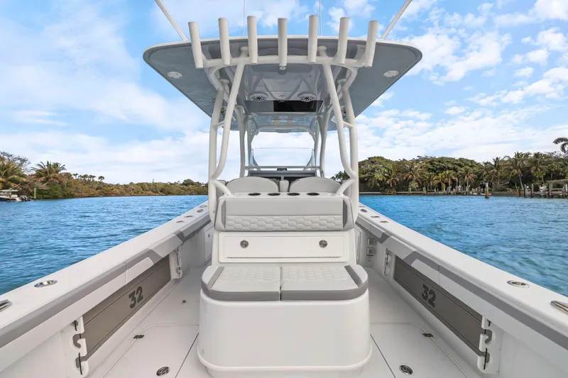  Yacht Photos Pics 2026 Yellowfin 32 Offshore boat on a scenic waterway with clear skies.