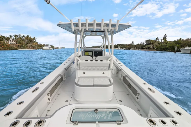  Yacht Photos Pics 2026 Yellowfin 32 Offshore boat on a scenic waterway, clear skies above.
