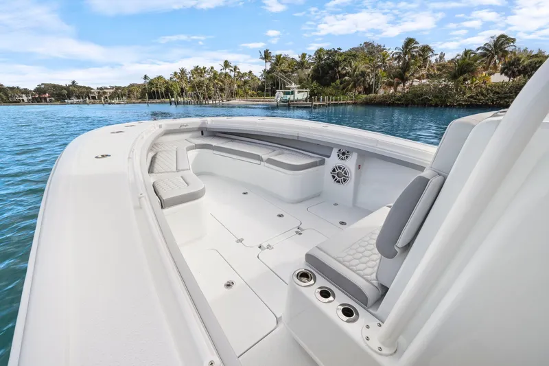  Yacht Photos Pics 2026 Yellowfin 32 Offshore boat interior with seating, on a calm blue waterway.