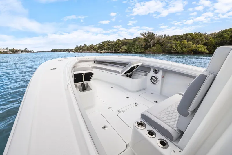 Yacht Photos Pics 2026 Yellowfin 32 Offshore boat interior, featuring sleek seating and modern design on calm waters.