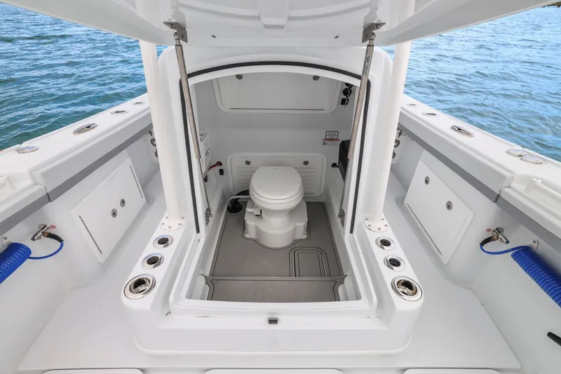  Yacht Photos Pics 2026 Yellowfin 32 Offshore boat interior with marine toilet, open sea view.