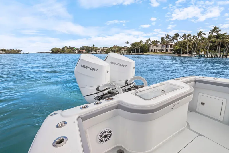  Yacht Photos Pics 2026 Yellowfin 32 Offshore boat with Mercury engines on a scenic waterway.