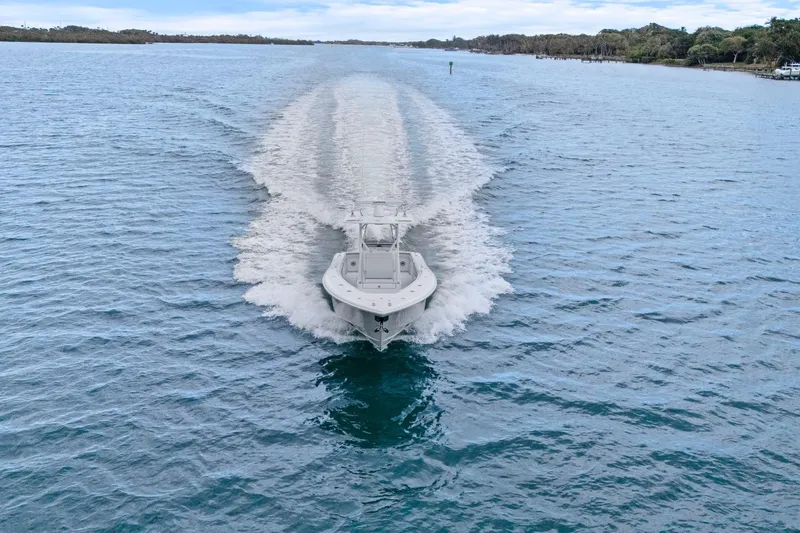  Yacht Photos Pics 2026 Yellowfin 32 Offshore boat cruising on open water, leaving a wake behind.