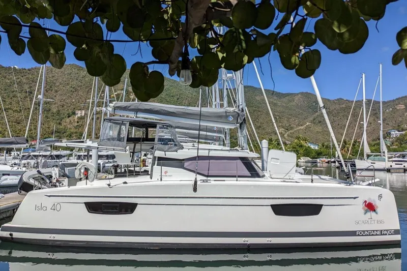 Scarlet Ibis Yacht Photos Pics 2023 Fountaine Pajot Isla 40 catamaran docked in a scenic marina setting.