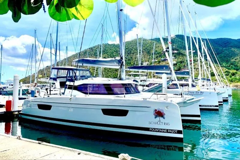 Scarlet Ibis Yacht Photos Pics 2023 Fountaine Pajot Isla 40 catamaran docked in a scenic marina.