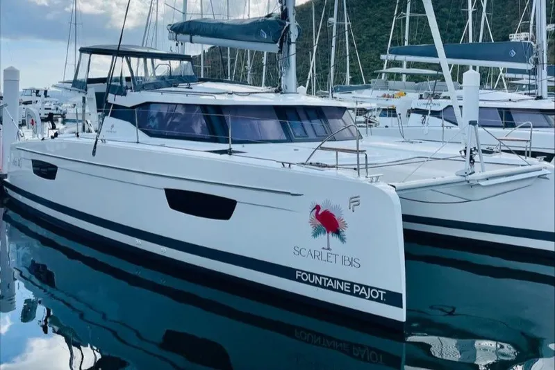 Scarlet Ibis Yacht Photos Pics 2023 Fountaine Pajot Isla 40 catamaran docked in marina, featuring sleek design and modern amenities.