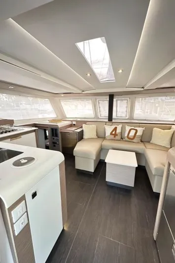 Scarlet Ibis Yacht Photos Pics Luxurious interior of 2023 Fountaine Pajot Isla 40 catamaran with modern design and spacious seating.