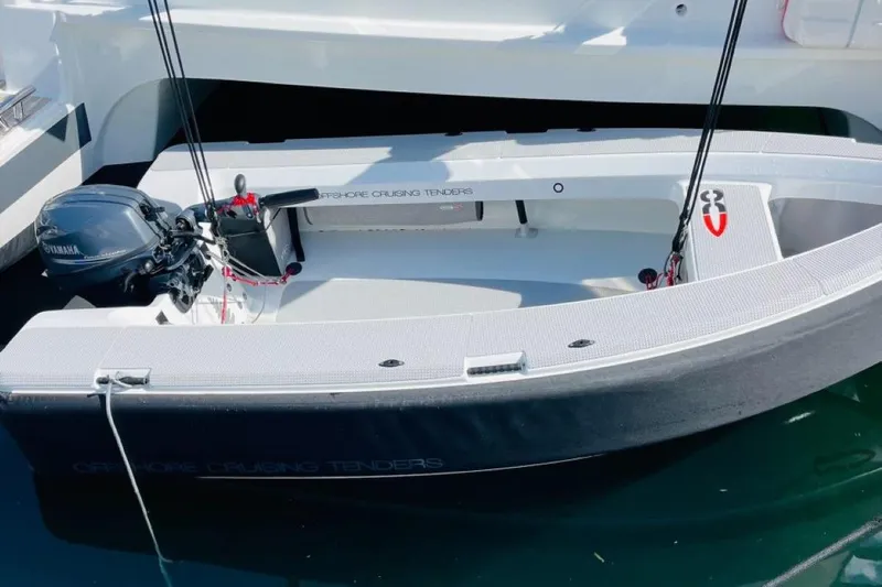 Scarlet Ibis Yacht Photos Pics 2023 Fountaine Pajot Isla 40 yacht with a sleek tender in the water.