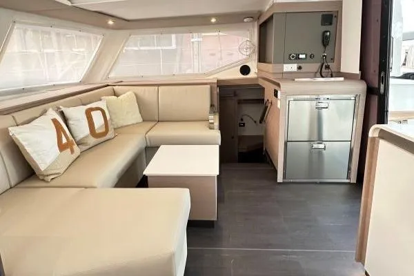 Scarlet Ibis Yacht Photos Pics Interior of 2023 Fountaine Pajot Isla 40 catamaran with modern seating and kitchen area.