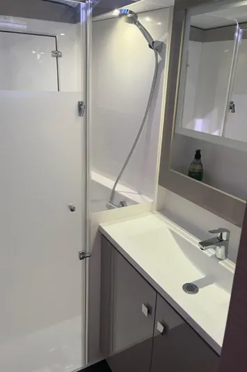 Scarlet Ibis Yacht Photos Pics 2023 Fountaine Pajot Isla 40 bathroom with modern shower and sleek vanity.