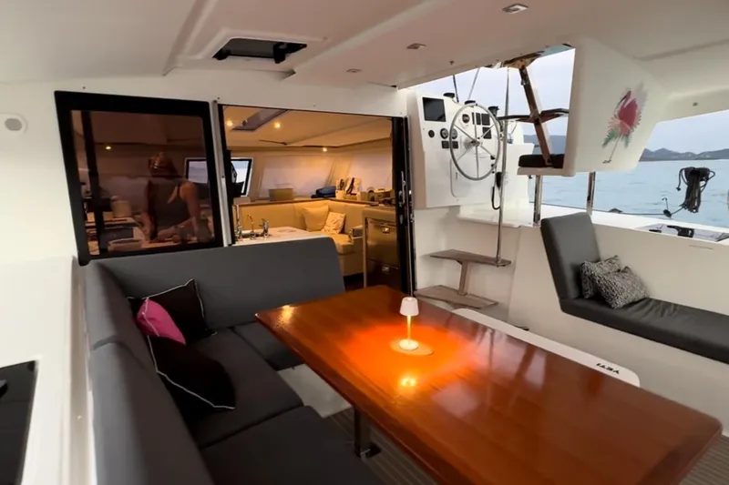Scarlet Ibis Yacht Photos Pics Interior view of 2023 Fountaine Pajot Isla 40 catamaran with elegant seating and dining area.