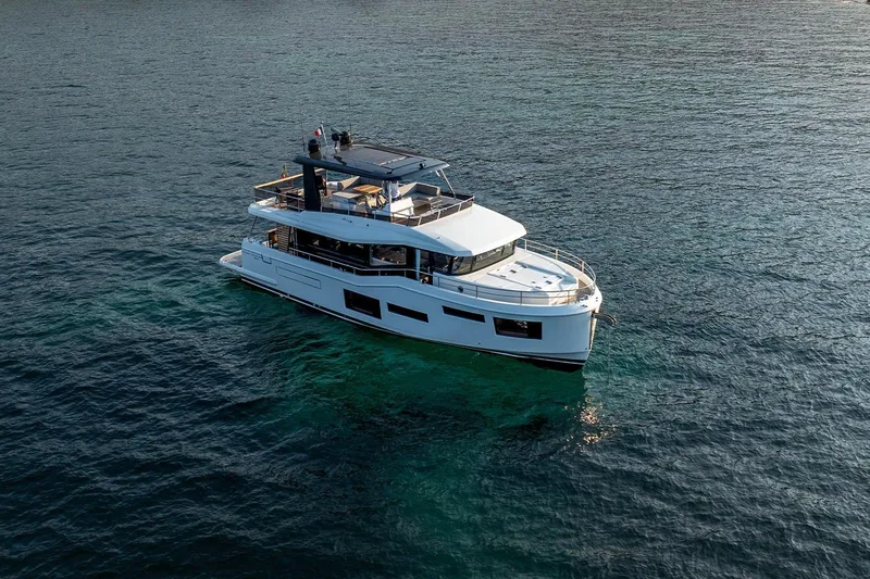  Yacht Photos Pics 2026 Beneteau Grand Trawler 63 yacht cruising on open water.