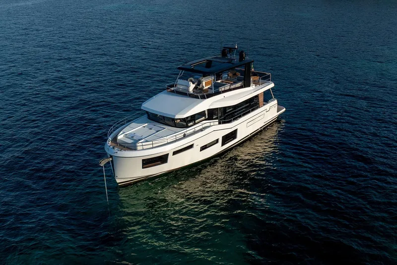  Yacht Photos Pics 2026 Beneteau Grand Trawler 63 yacht on calm blue ocean waters.