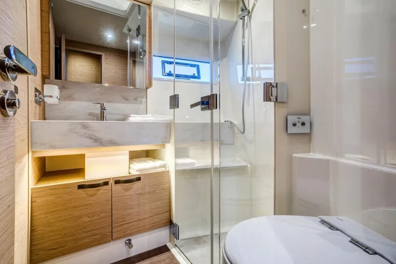  Yacht Photos Pics Luxurious bathroom in 2026 Beneteau Grand Trawler 63 yacht, featuring modern fixtures and elegant design.