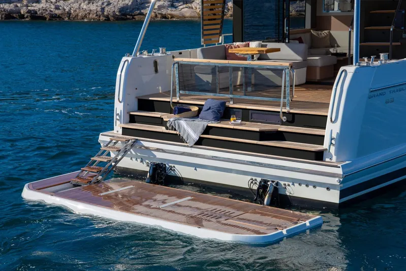  Yacht Photos Pics 2026 Beneteau Grand Trawler 63 yacht with open deck and swim platform on the water.