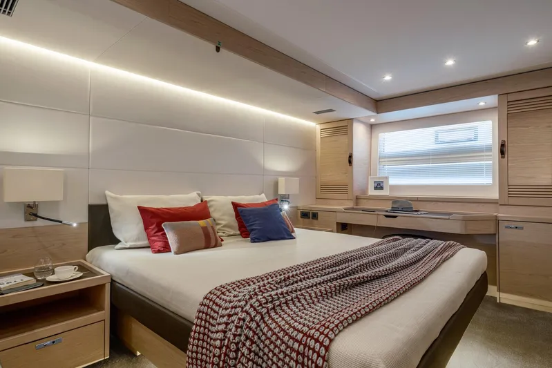  Yacht Photos Pics Luxurious bedroom interior of 2026 Beneteau Grand Trawler 63 yacht, featuring modern design and cozy ambiance.