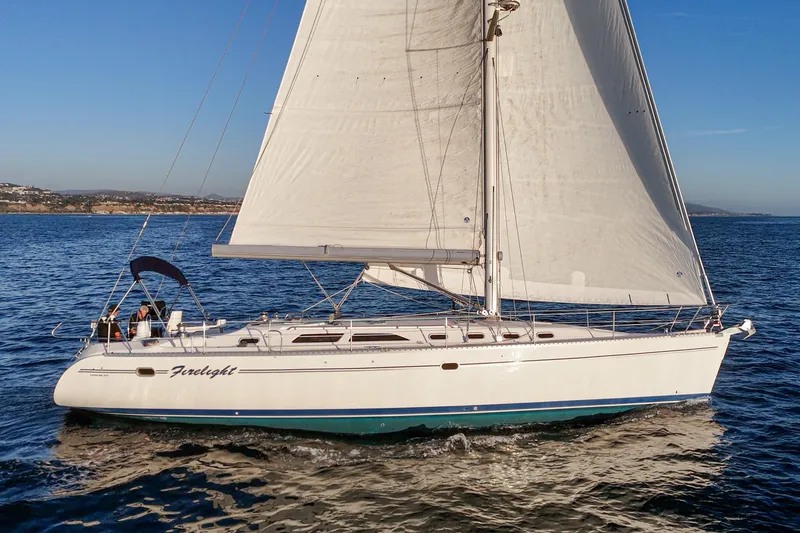 Firelight Yacht Photos Pics Sailing yacht Catalina 470, 1999 model, cruising on open water under clear skies.