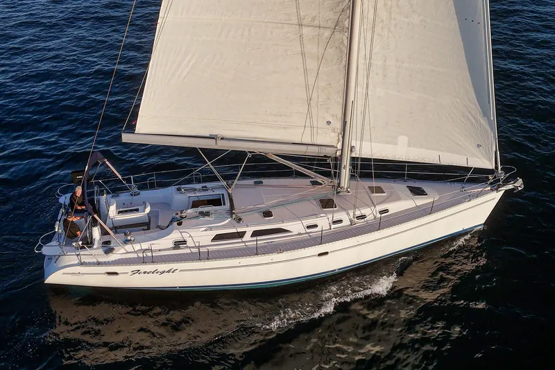 Firelight Yacht Photos Pics Sailing yacht Catalina 470, 1999 model, cruising on open water with full sails.