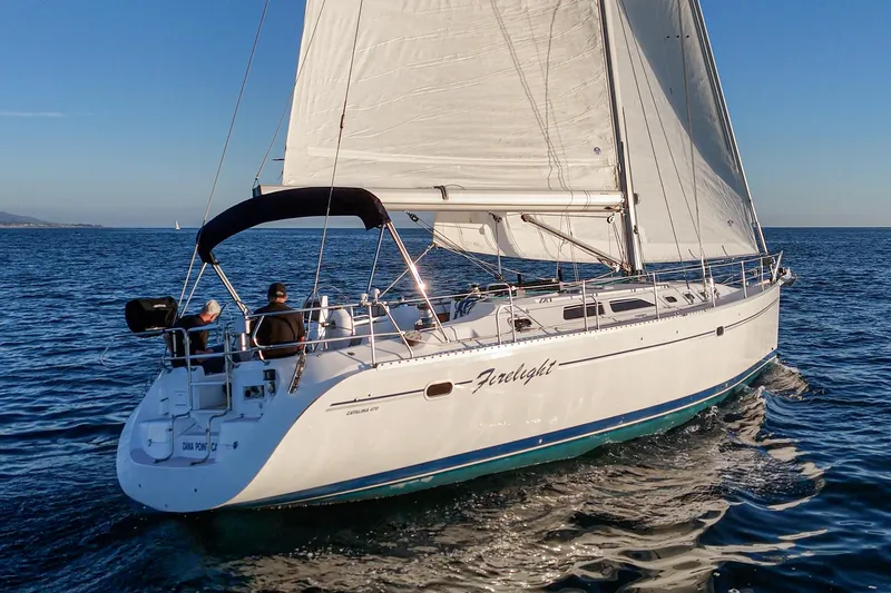 Firelight Yacht Photos Pics Sailing yacht Catalina 470, 1999 model, cruising on open water under clear skies.