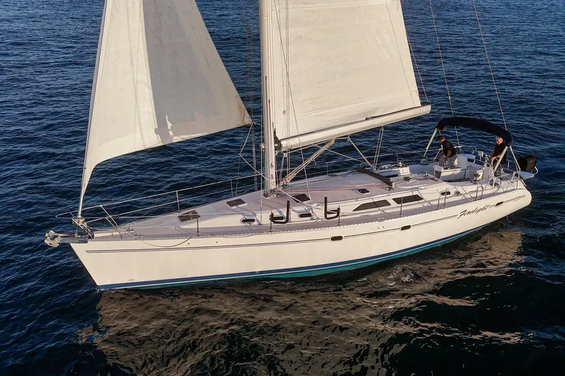Firelight Yacht Photos Pics Sailing yacht Catalina 470, 1999 model, cruising on open water with full sails.