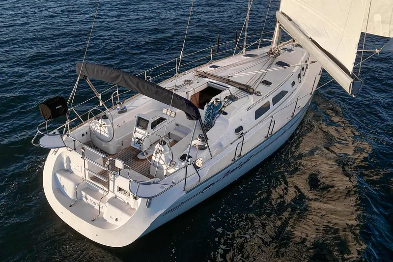 Firelight Yacht Photos Pics Sailing yacht Catalina 470, 1999 model, cruising on open water.