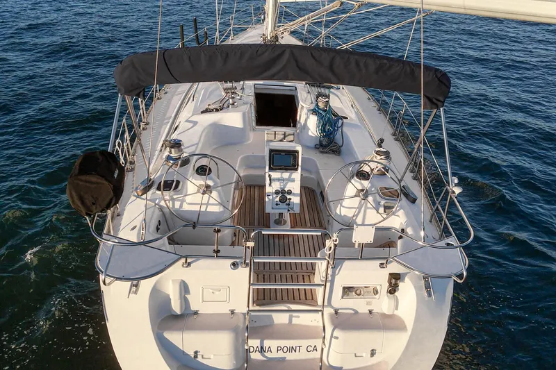 Firelight Yacht Photos Pics 1999 Catalina 470 sailboat on water, featuring dual steering wheels and spacious deck.