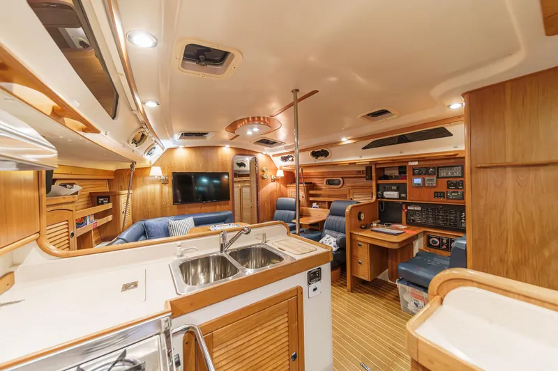 Firelight Yacht Photos Pics Luxurious interior of a 1999 Catalina 470 yacht with modern amenities and wooden finishes.