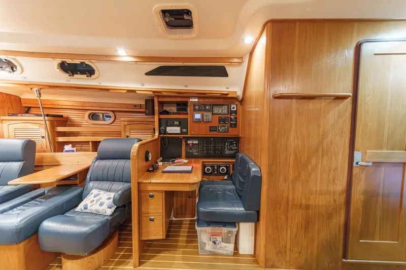 Firelight Yacht Photos Pics Luxurious interior of 1999 Catalina 470 yacht with wood paneling and blue seating.