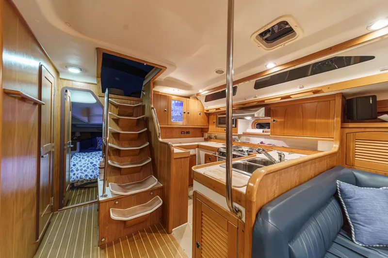 Firelight Yacht Photos Pics Interior of 1999 Catalina 470 yacht with wooden cabinetry and cozy seating area.