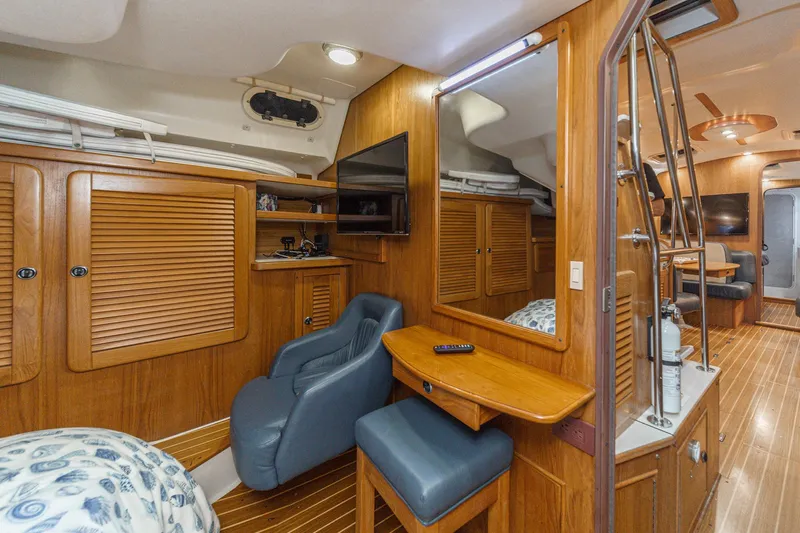 Firelight Yacht Photos Pics Interior of a 1999 Catalina 470 yacht with wooden cabinetry and seating.