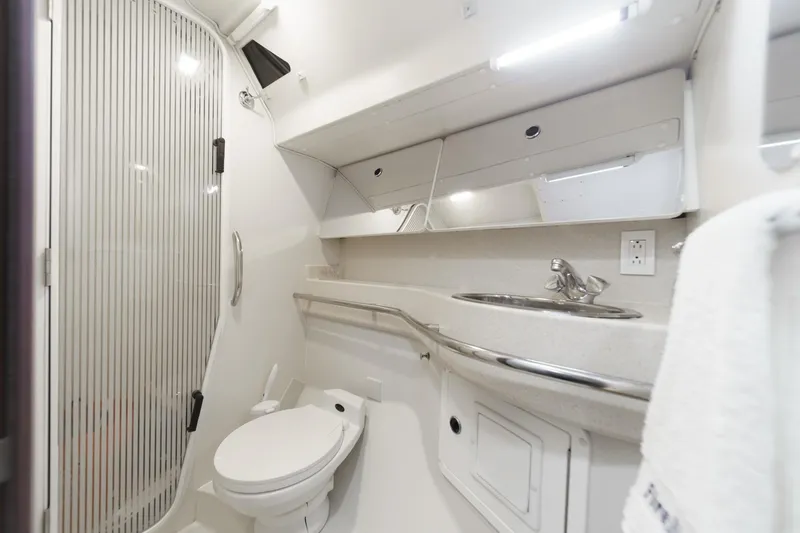 Firelight Yacht Photos Pics Modern bathroom in a 1999 Catalina 470 yacht, featuring a shower, toilet, and sink.