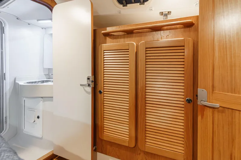 Firelight Yacht Photos Pics Interior of 1999 Catalina 470 yacht featuring wooden cabinets and a compact bathroom sink.