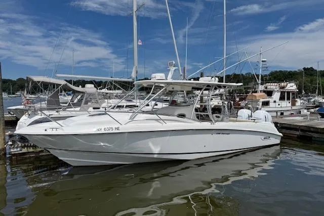  Yacht Photos Pics 2006 Boston Whaler 320 Outrage Cuddy Cabin docked at marina under blue sky.