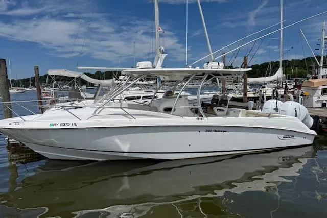  Yacht Photos Pics 2006 Boston Whaler 320 Outrage Cuddy Cabin docked in a marina.