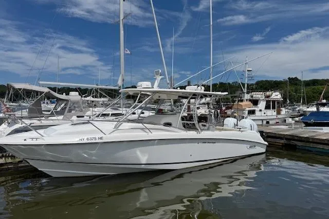  Yacht Photos Pics 2006 Boston Whaler 320 Outrage Cuddy Cabin docked at marina under blue sky.