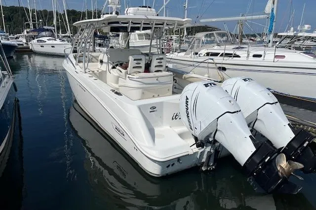  Yacht Photos Pics 2006 Boston Whaler 320 Outrage Cuddy Cabin docked in a marina.