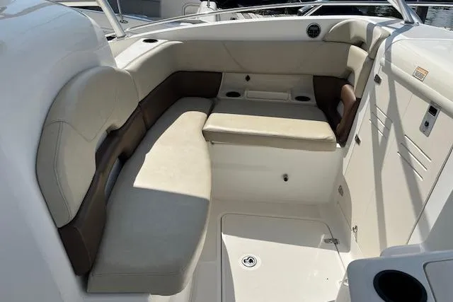  Yacht Photos Pics 2006 Boston Whaler 320 Outrage Cuddy Cabin interior seating area with beige cushions.