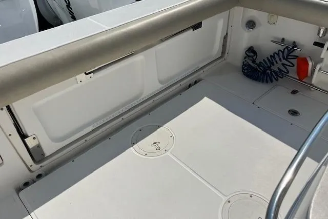  Yacht Photos Pics 2006 Boston Whaler 320 Outrage Cuddy Cabin deck, featuring storage and clean design.