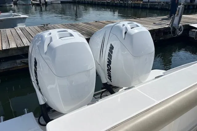  Yacht Photos Pics 2006 Boston Whaler 320 Outrage Cuddy Cabin with twin Mercury outboard engines at dock.