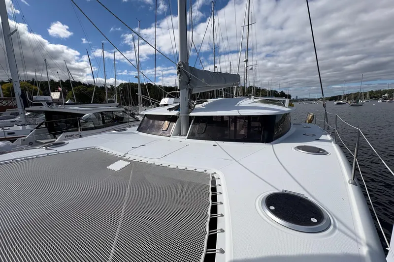 Littlest Hobo Yacht Photos Pics 2009 Fountaine Pajot Orana 44 Maestro catamaran docked in a marina under cloudy skies.