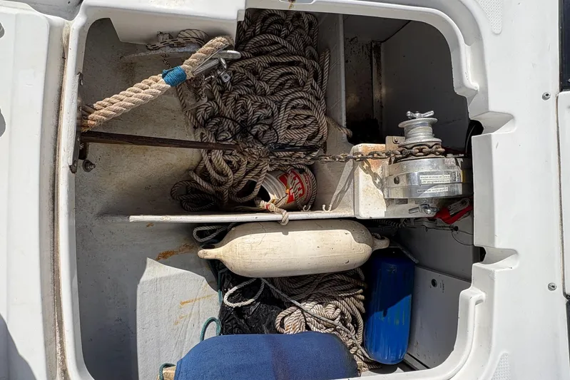 Littlest Hobo Yacht Photos Pics Storage compartment of 2009 Fountaine Pajot Orana 44 with ropes, anchor, and fender.